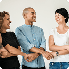A group of people standing together holding hands